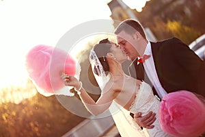 Bride and groom holding a candy floss