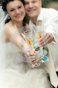 Bride and groom holding glasses of champagne