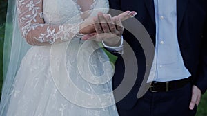 Bride and groom holding gold wedding rings in their hands