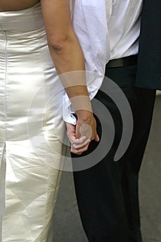 Bride and groom holding hands