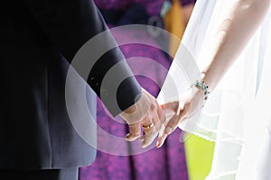 Bride and groom holding hands