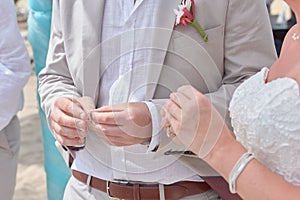 Bride and Groom Holding hands and exchanging rings