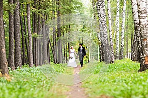 Bride and groom holding hands outdoors