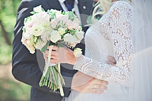 Bride and groom holding hands. Wedding.Just married couple embraced.