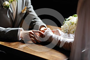 Bride and groom holding their hands