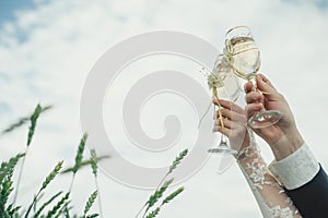 Bride and groom holding wedding champagne glasses