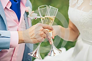 Bride and groom holding wedding glasses