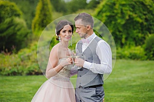 Bride and groom holding wine glasses