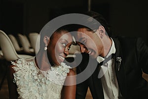 Bride and groom hug each other. Interracial marriage. Asian bride and groom