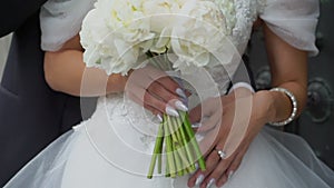 Bride and groom are hugging. Couple in love in wedding dress and a classic suit.