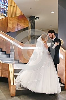 Bride and groom hugging and kissing on their wedding day. Creating a new family, a happy couple in love, a Man and a woman love e