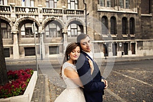 Bride and groom hugging in the old town street. Weding couple in love. Weeding in Budapest