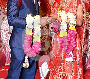 Bride and groom at the Indian wedding garlands or Jaimala ceremony