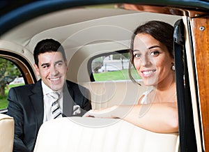Bride and groom inside a beautiful classic car
