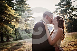 Bride and Groom kiss in the forest