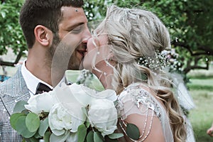 The bride and groom kiss in the forest at the wedding ceremony. selective focus. film grain