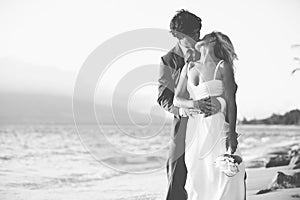 Bride and Groom Kissing on the Beach