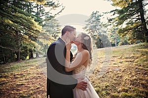 Bride and Groom kissing in forest