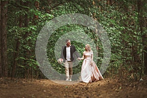 Bride and groom kissing in the summer forest