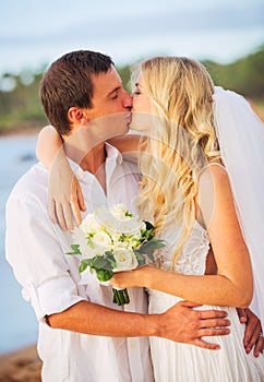 Bride and Groom, Kissing at Sunset on a Beautiful Tropical Beach