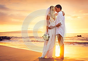 Bride and Groom, Kissing at Sunset on a Beautiful Tropical Beach