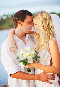 Bride and Groom, Kissing at Sunset on a Beautiful Tropical Beach