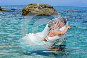 Bride and groom kissing - trash the dress