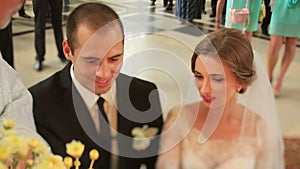 Bride and groom kneel before the altar and saying oaths during wedding ceremony