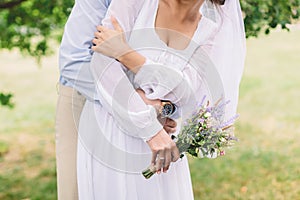 Bride and groom with lavender bouquet