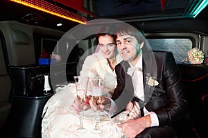 Bride and groom in limousine