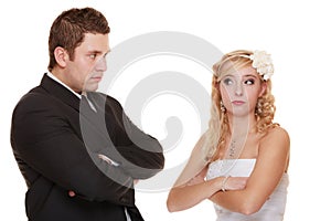 Bride and groom looking at each other offended