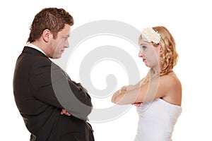 Bride and groom looking at each other offended