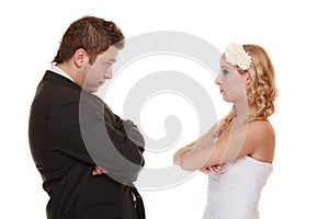 Bride and groom looking at each other offended