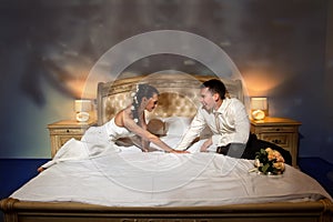 Bride and groom lying on bed