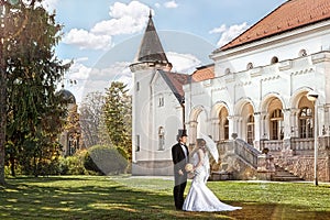 Bride and groom meet in front of the old mansion, romantic, nostalgic scene with sunshine