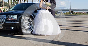 Bride and groom near car