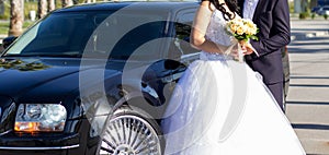 Bride and groom near car