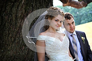 Bride and groom near oak