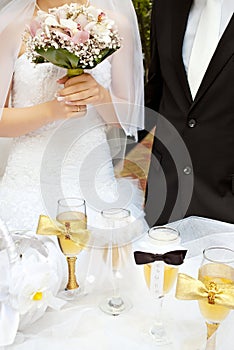 Bride and groom near wedding table