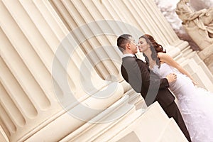 Bride and groom near white columns