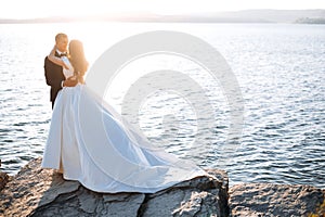 Bride and groom, newlyweds, honeymoon on the beach sunset sun