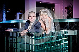 bride and groom next to bar