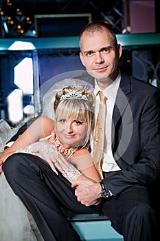 Bride and groom next to bar