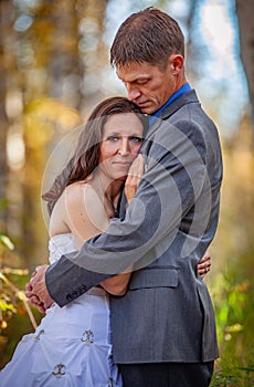 Bride and groom in outdoors during fall