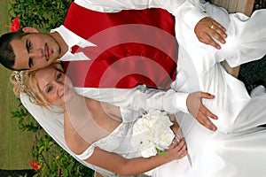 Bride and groom on park bench