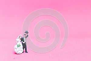 Bride and groom on pink background