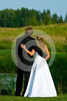 Bride and groom at pond
