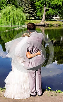 Bride and groom on the pond