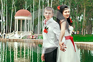 Bride and groom posing in amusement park