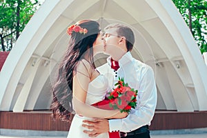 Bride and groom posing in amusement park